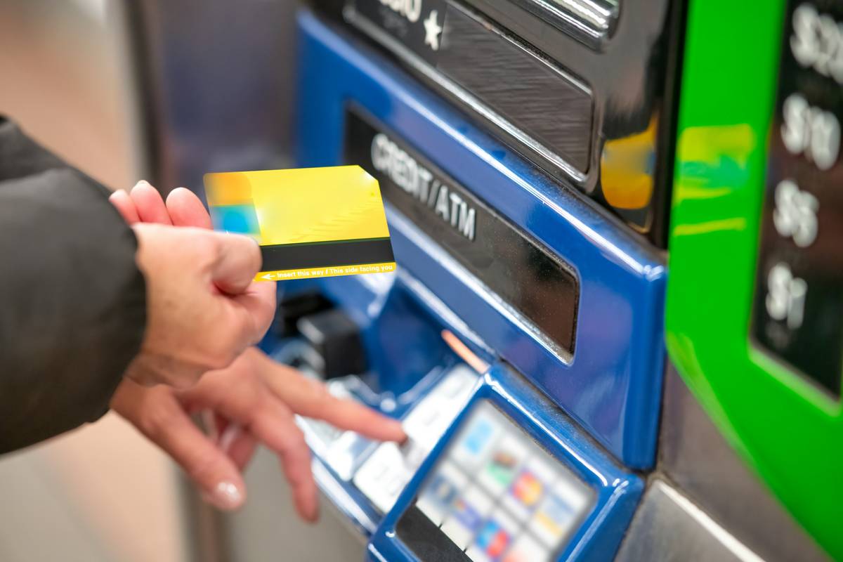 Traveler using credit card car rental insurance at airport rental desk